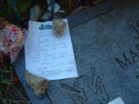 Note left for Jack on his grave by "MLS". (Note beer bottles, miniatures, pencils and writings, etc.